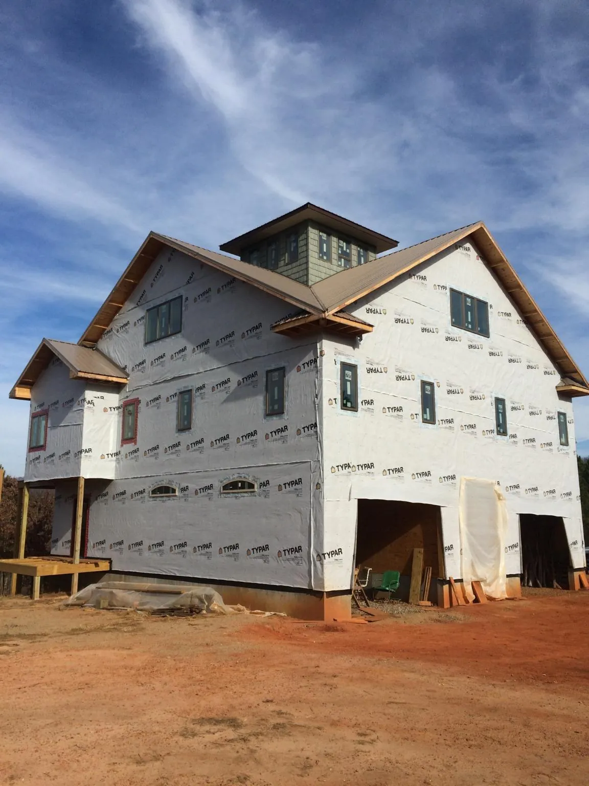 New two story house under construction with a cupola and gabled roofs in Lincoln City